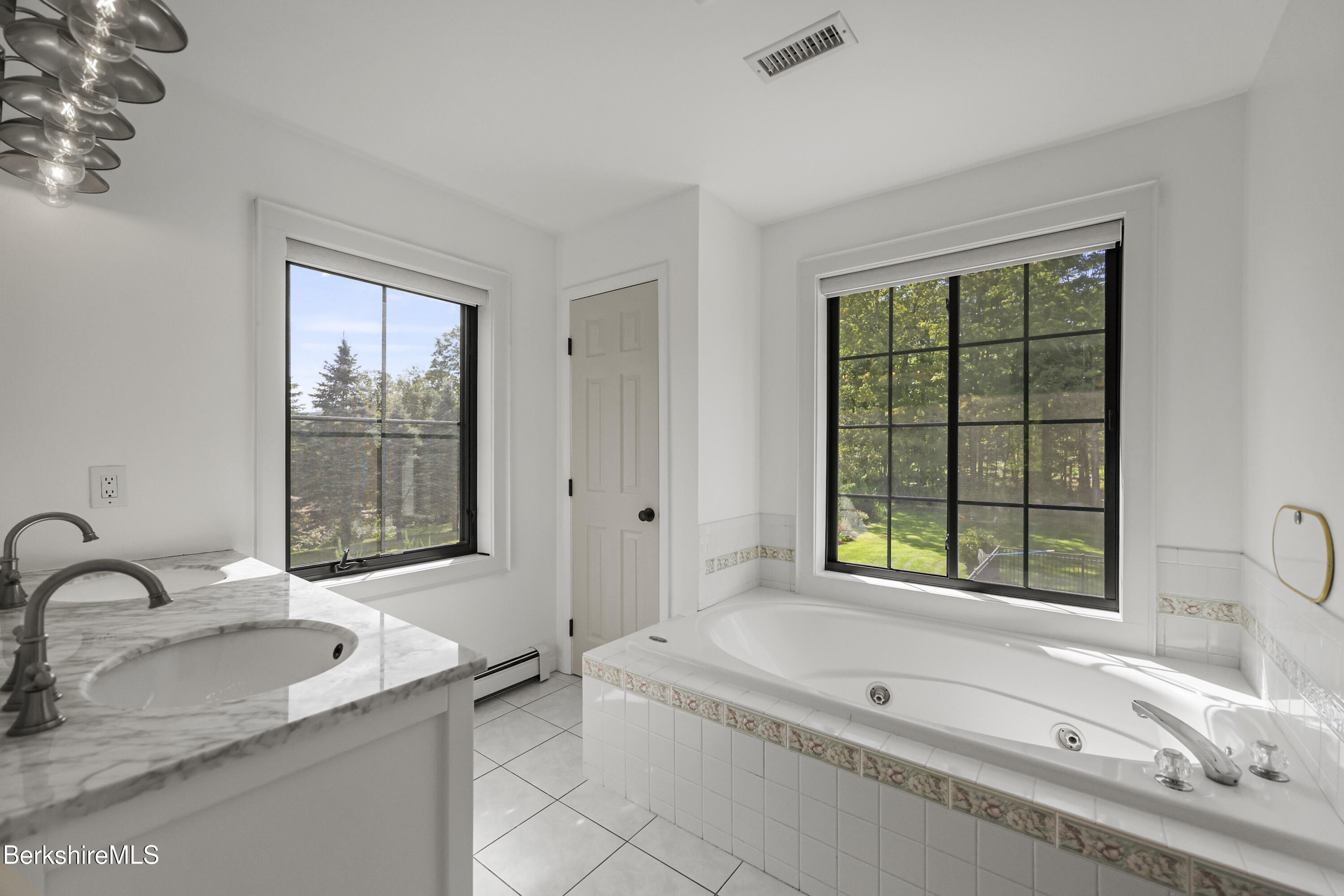 65 Johnson Road Dalton, MA 01226 - Photo 35 of 76 a bathroom with a granite countertop tub sink and mirror