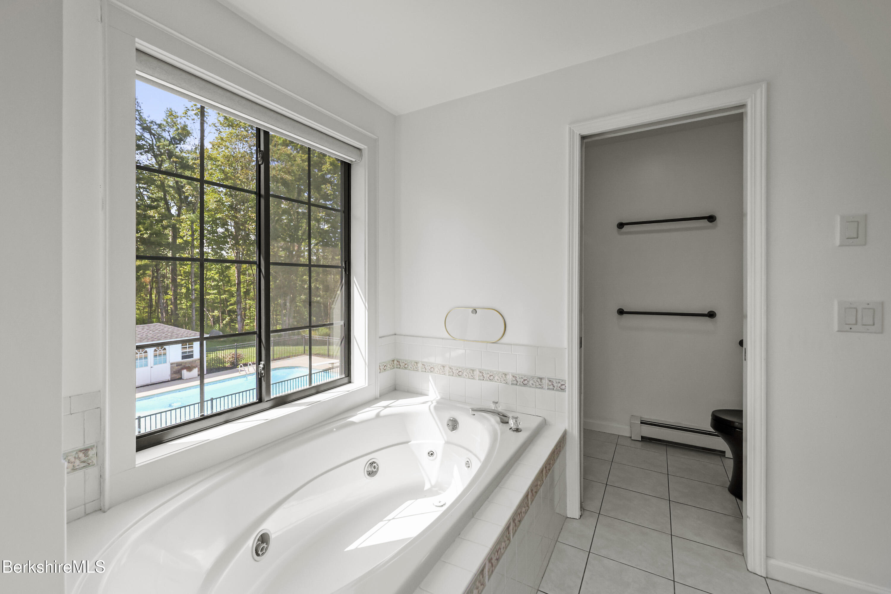 65 Johnson Road Dalton, MA 01226 - Photo 36 of 76 a bathroom with a tub a sink and a large window