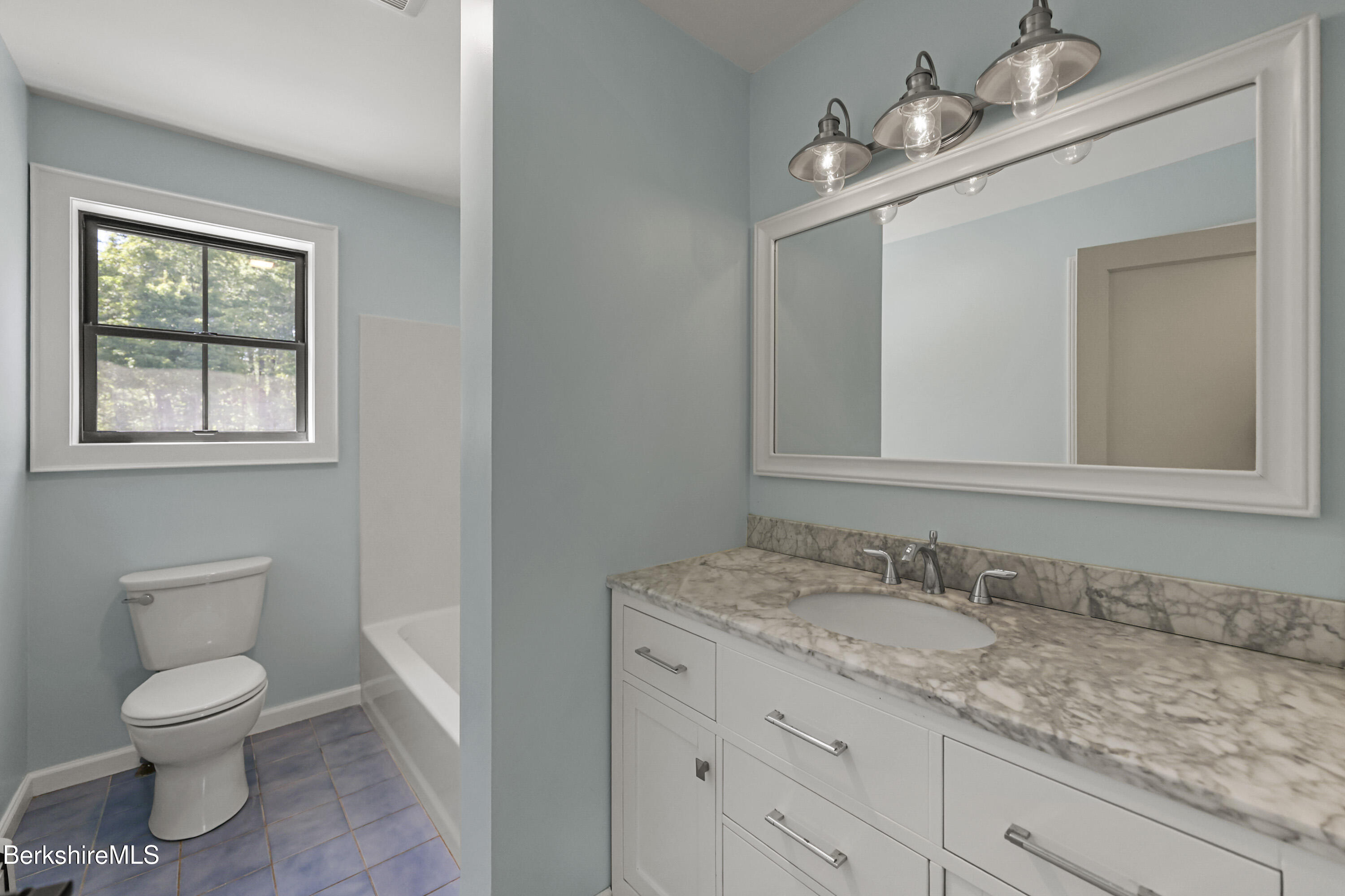 65 Johnson Road Dalton, MA 01226 - Photo 48 of 76 a bathroom with a granite countertop toilet a sink and mirror