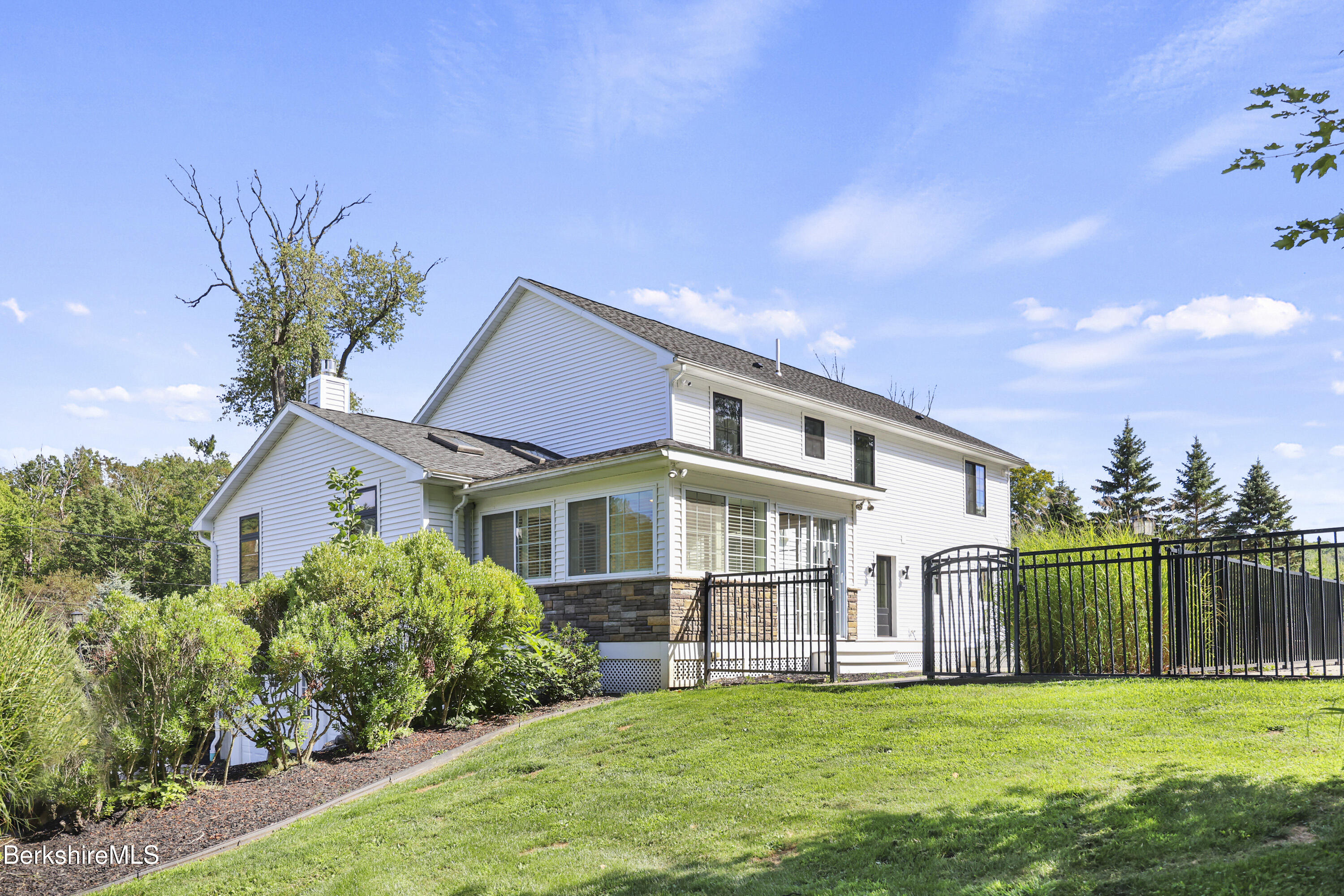 65 Johnson Road Dalton, MA 01226 - Photo 62 of 76 a view of a house with a yard and potted plants