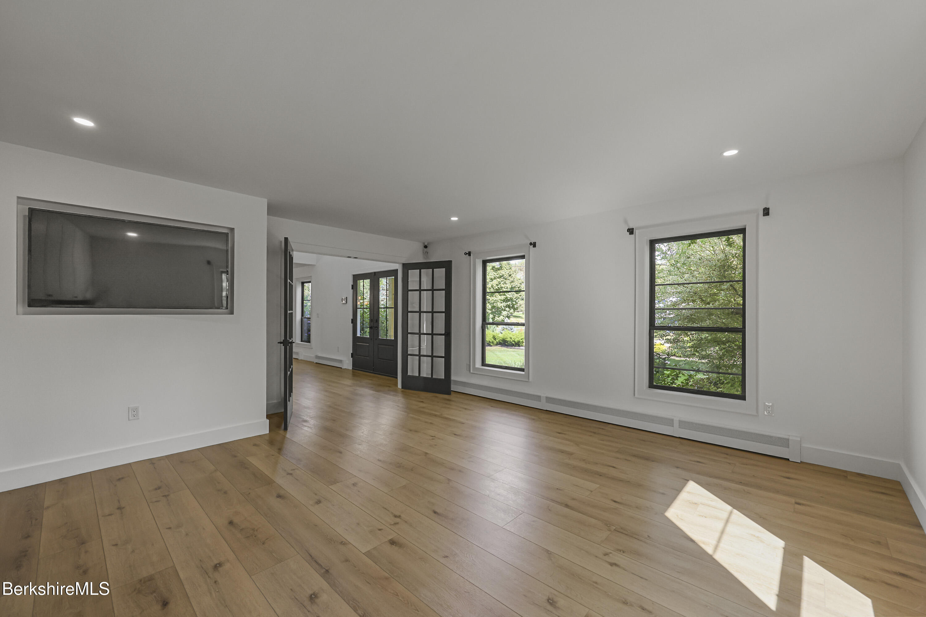 65 Johnson Road Dalton, MA 01226 - Photo 7 of 76 a view of an empty room with wooden floor and a window