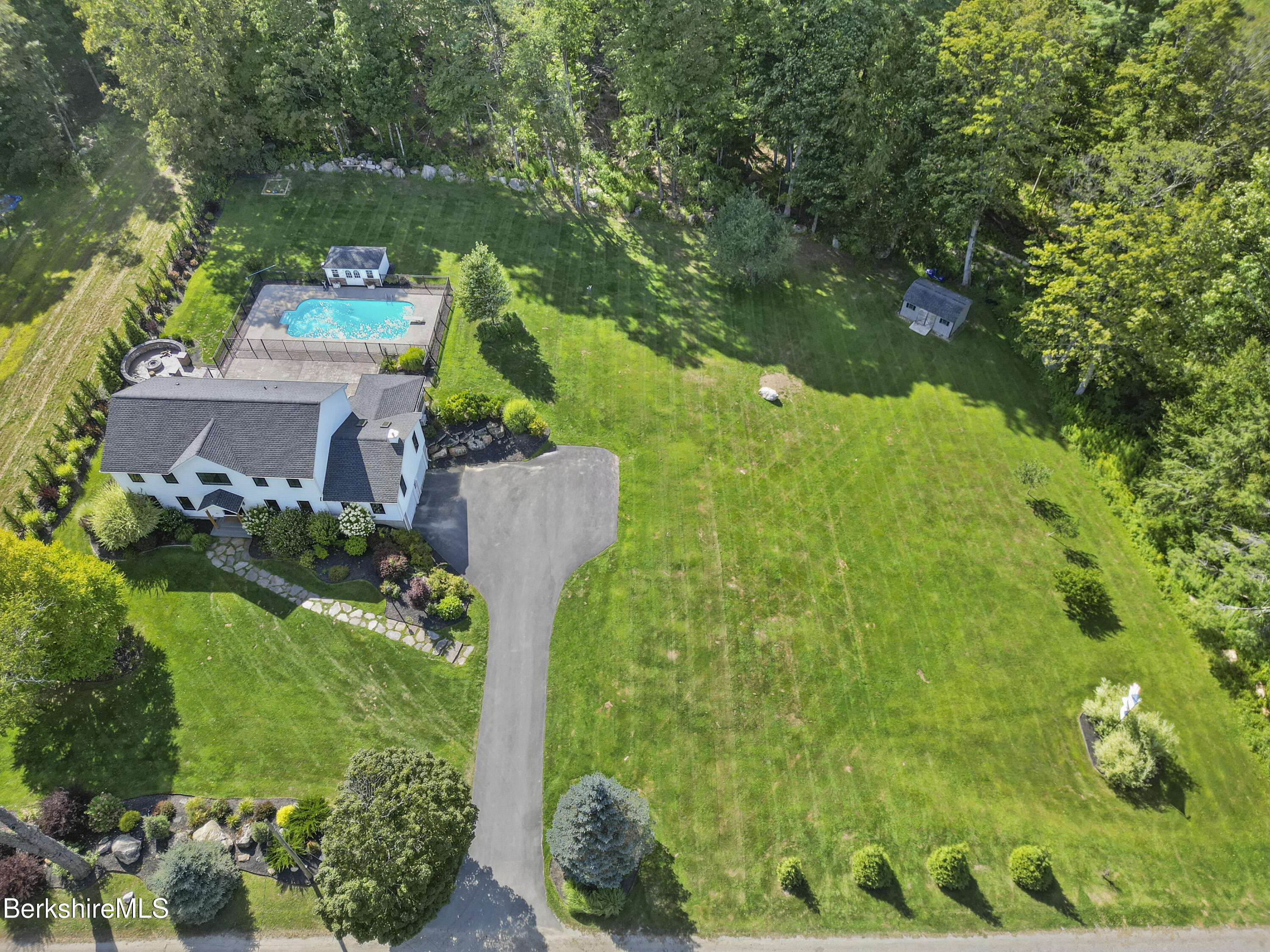 65 Johnson Road Dalton, MA 01226 - Photo 74 of 76 a backyard of a house with lots of green space and plants