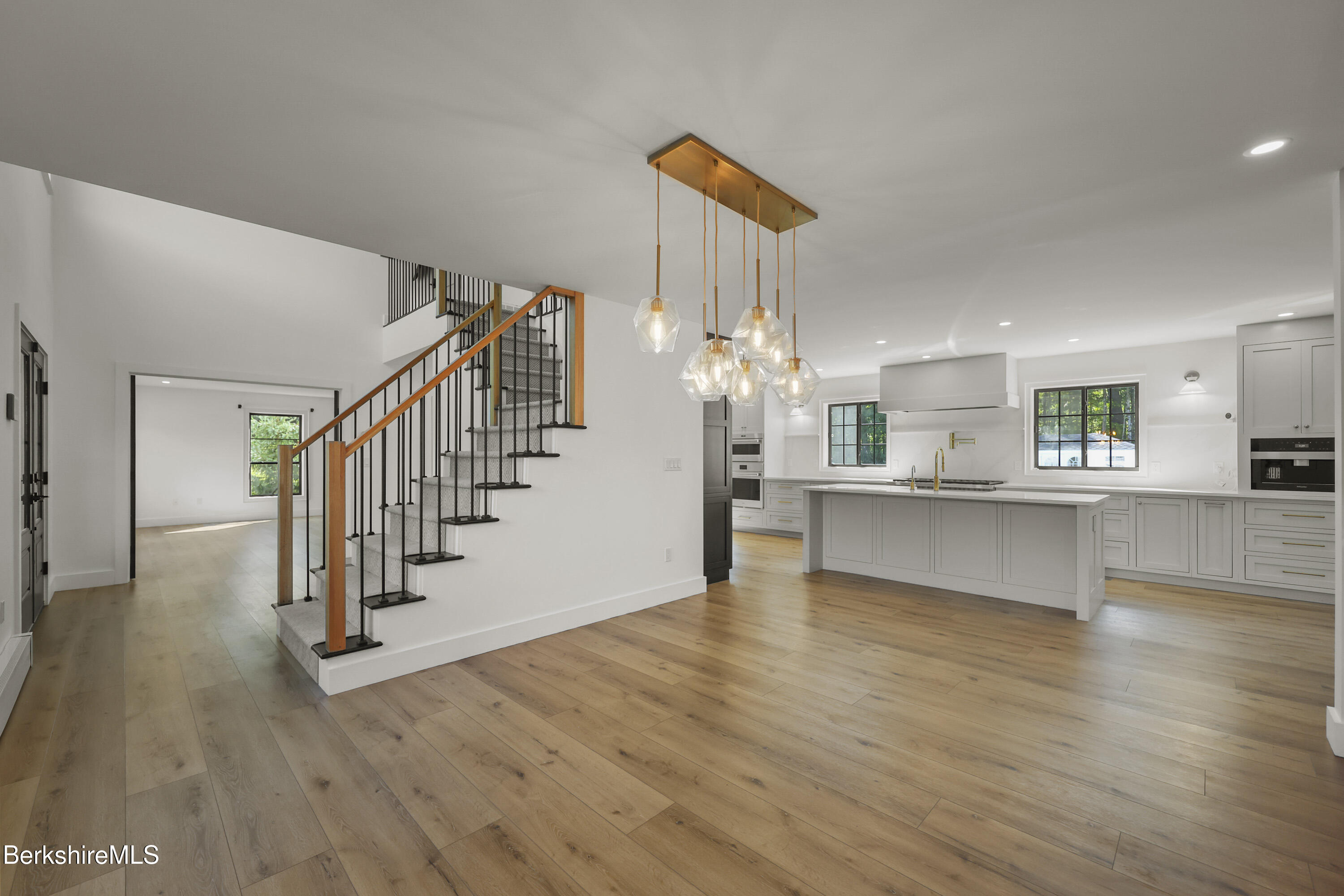 65 Johnson Road Dalton, MA 01226 - Photo 10 of 76 a view of a kitchen with wooden floor and a living room