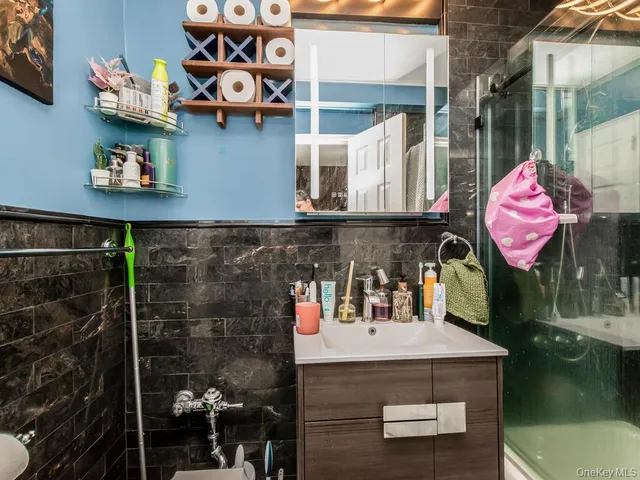 a kitchen area with lots of clutter and cabinets