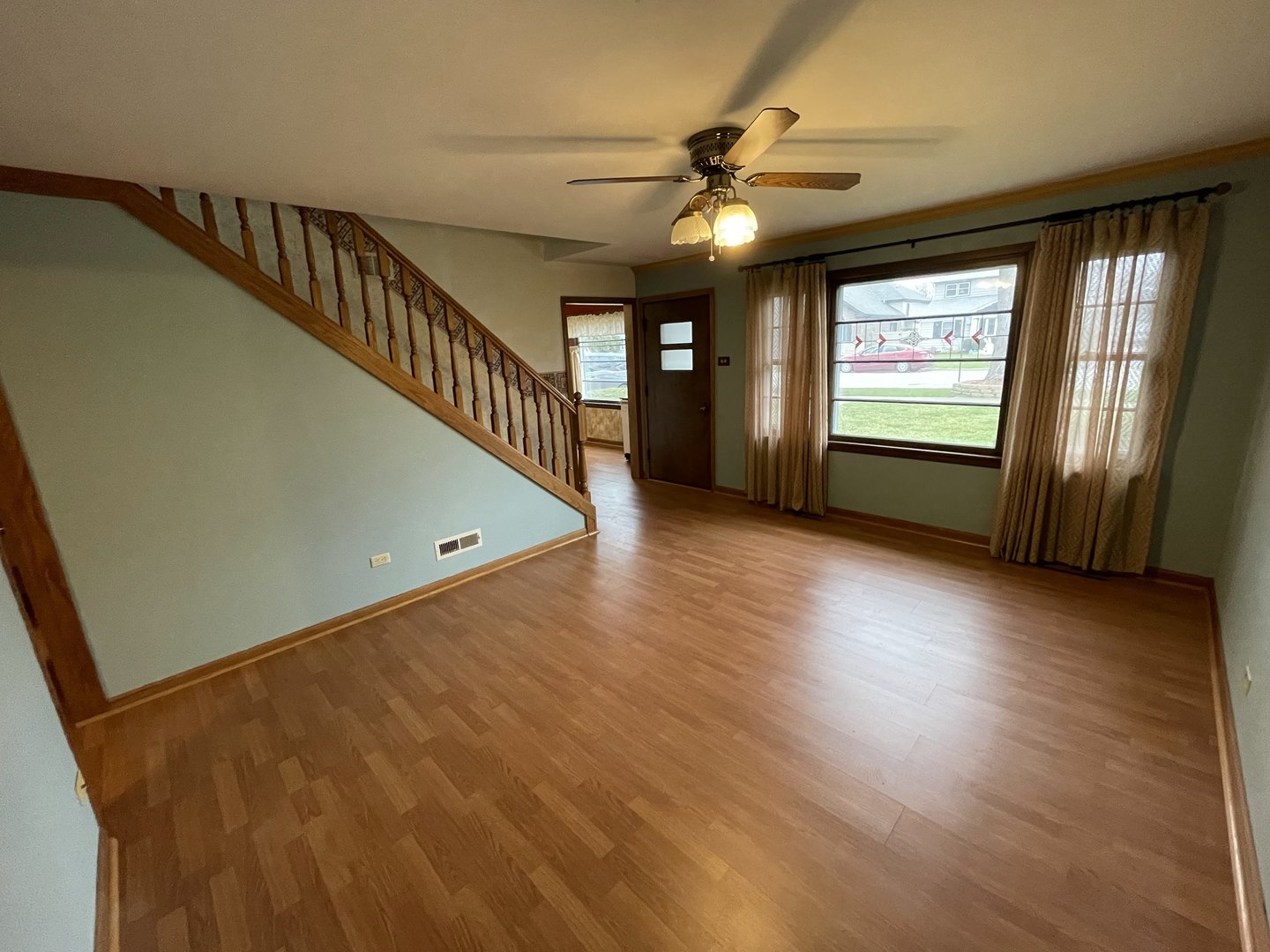 10720 Princess Avenue Chicago Ridge, IL 60415 - Photo 12 of 34 a view of an empty room with a window and wooden floor