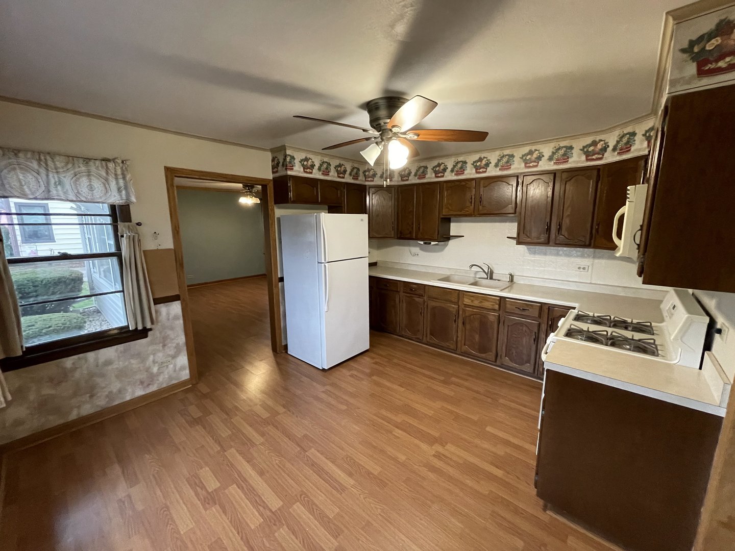 10720 Princess Avenue Chicago Ridge, IL 60415 - Photo 15 of 34 a kitchen with stainless steel appliances a sink cabinets and wooden floor