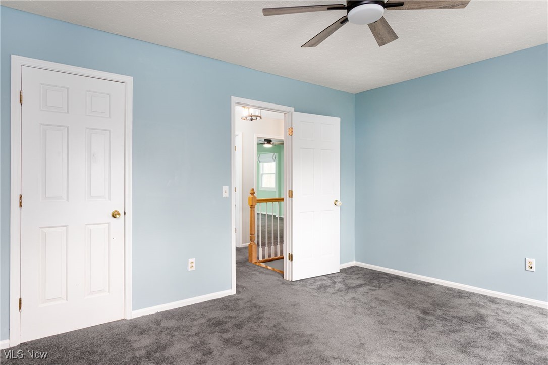 14566 West Ridge Road Novelty, OH 44072 - Photo 38 of 49 Unfurnished bedroom with baseboards, a ceiling fan, and carpet floors