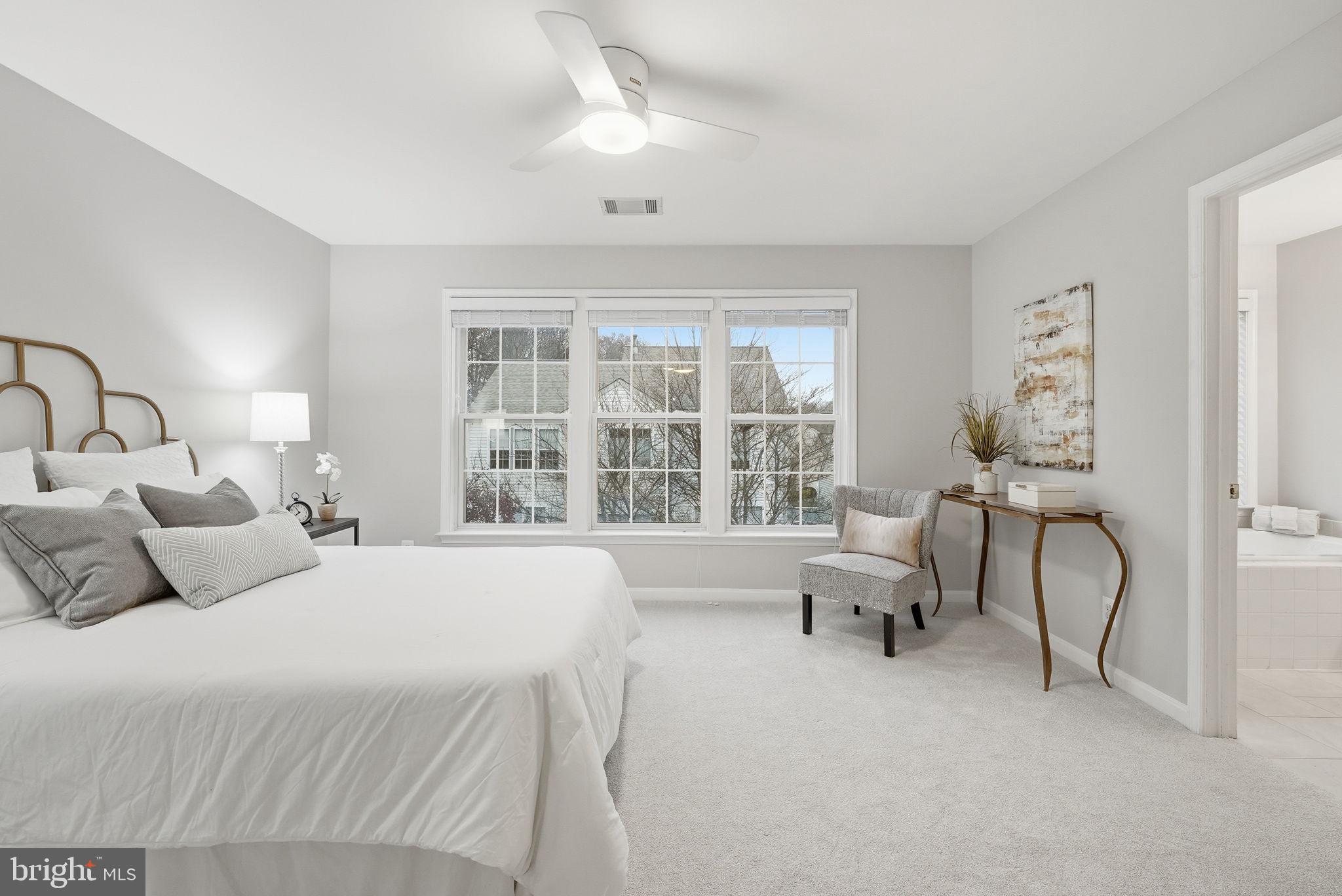 12402 Brown Fox Way Reston, VA 20191 - Photo 24 of 52 a bedroom with a bed and a large window