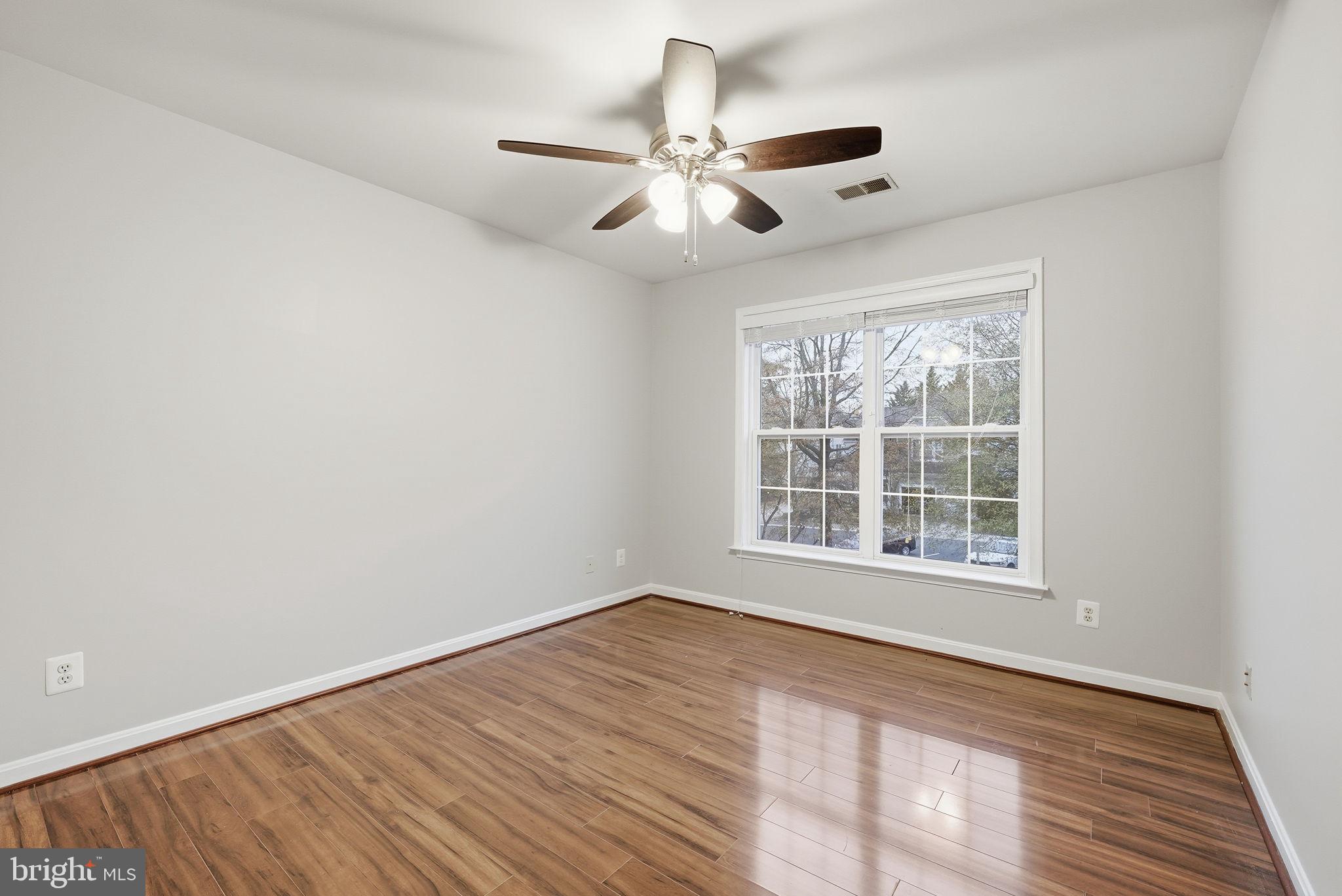12402 Brown Fox Way Reston, VA 20191 - Photo 37 of 52 a view of an empty room with wooden floor and a window