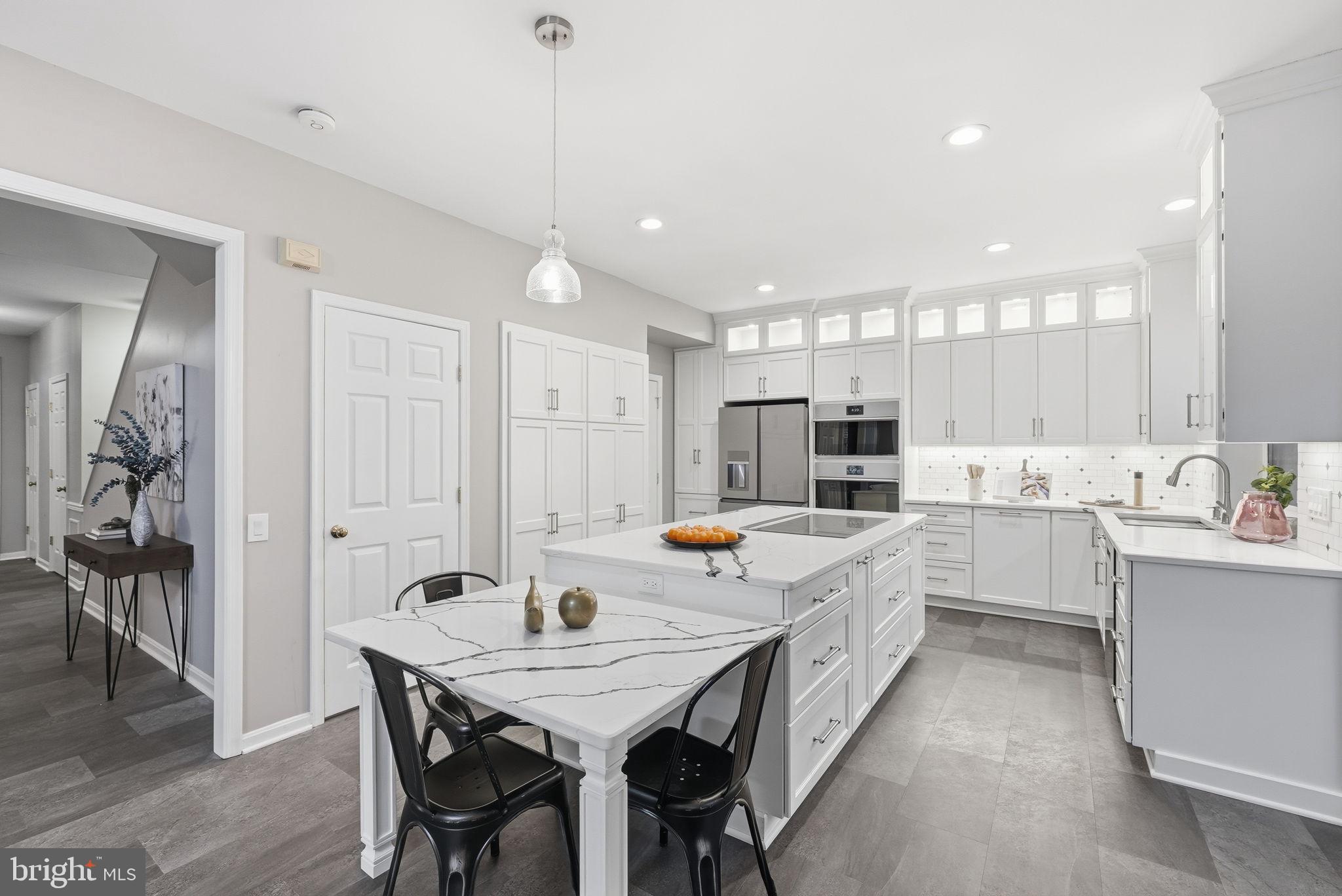 12402 Brown Fox Way Reston, VA 20191 - Photo 4 of 52 a large kitchen with a table and chairs