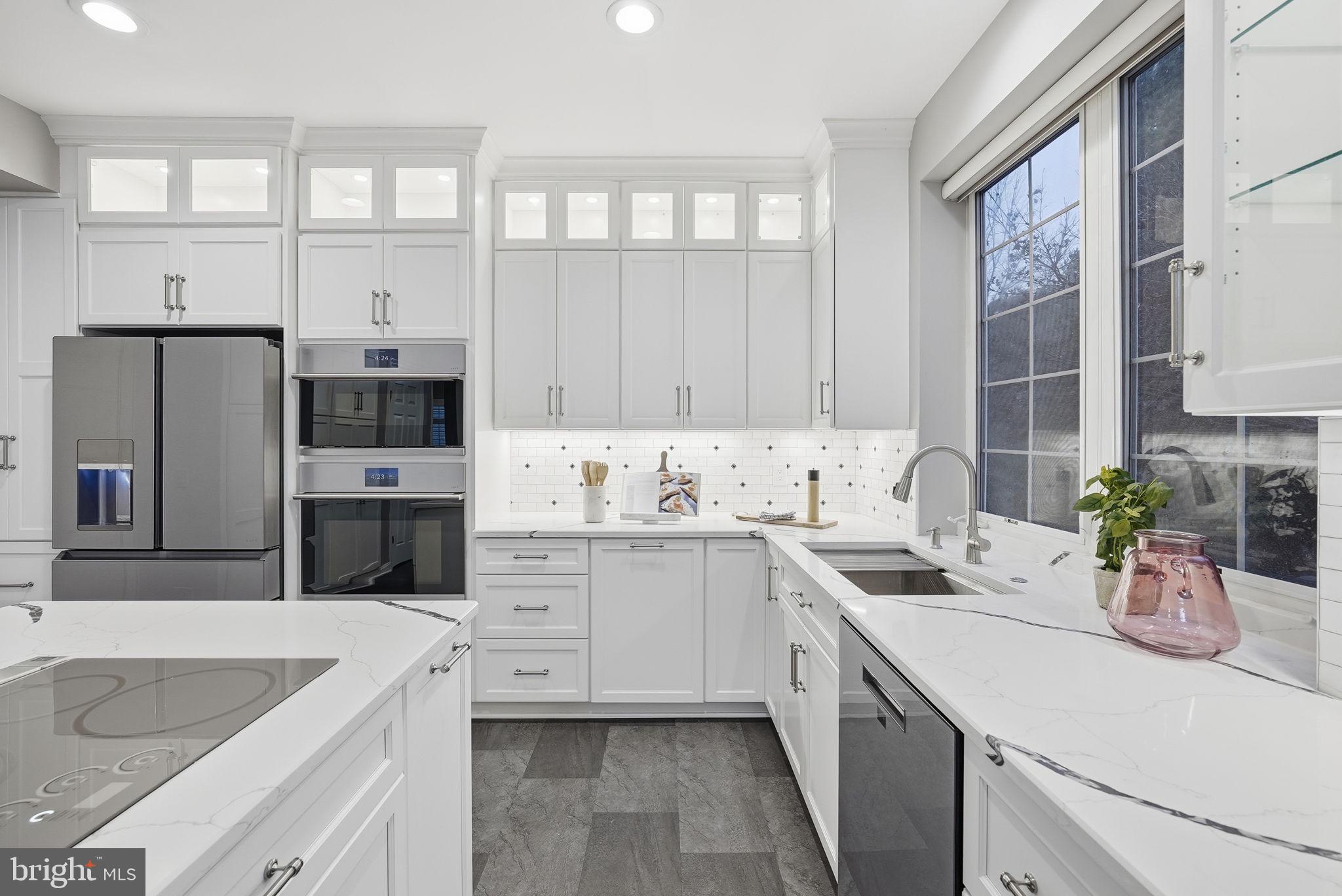 12402 Brown Fox Way Reston, VA 20191 - Photo 6 of 52 a kitchen with cabinets appliances a sink and a counter top space