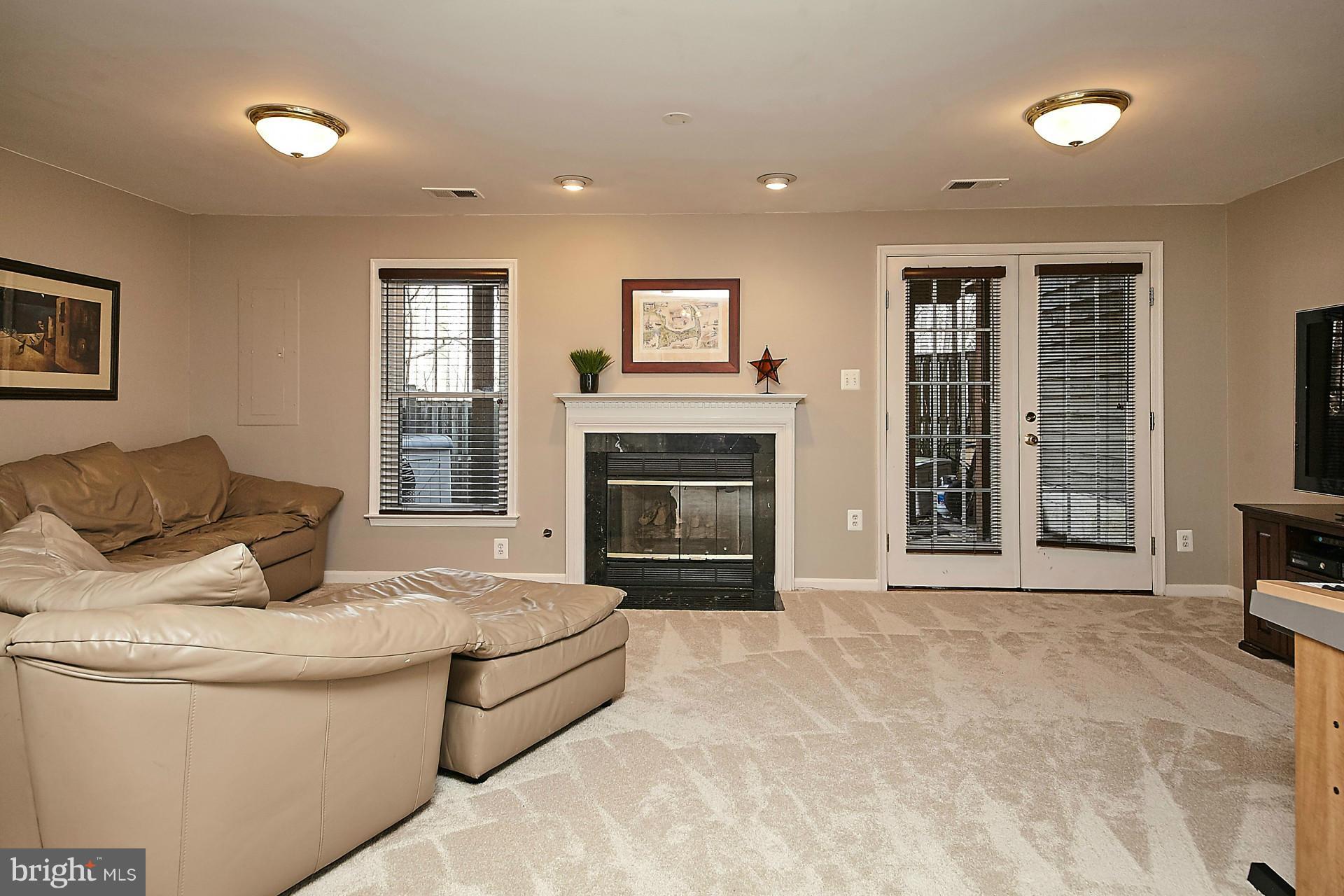 1217 Weatherstone Court Reston, VA 20194 - Photo 23 of 30 Lower Level Recreation Room w/ Gas Fireplace
