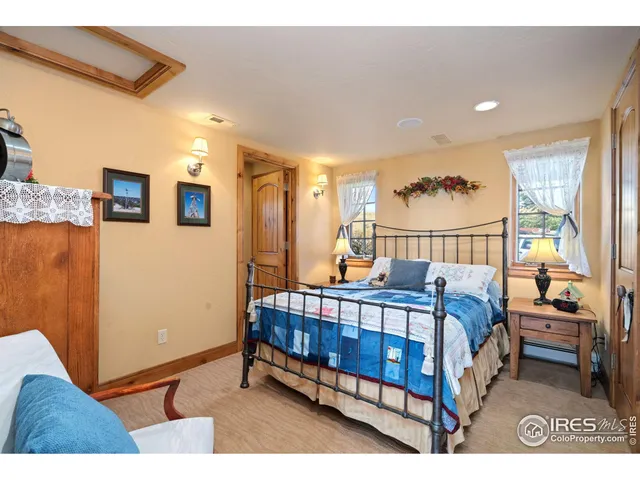 a view of a bedroom with furniture and window