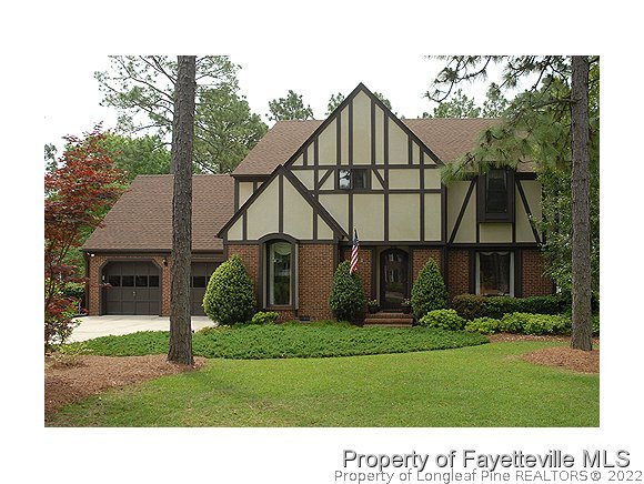 6823 Uppingham Road Fayetteville, NC 28306 - Photo 1 of 18 a view of a house with a yard and plants