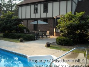 6823 Uppingham Road Fayetteville, NC 28306 - Photo 17 of 18 a view of a house with backyard and sitting area