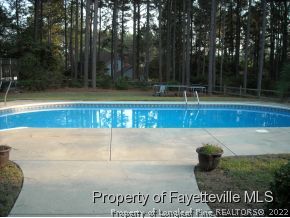 6823 Uppingham Road Fayetteville, NC 28306 - Photo 18 of 18 a view of a swimming pool and trees