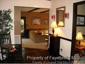 6823 Uppingham Road Fayetteville, NC 28306 - Photo 2 of 18 a living room with furniture and a painting on the wall
