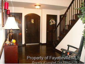 6823 Uppingham Road Fayetteville, NC 28306 - Photo 5 of 18 a view of a hallway with wooden floor and staircase