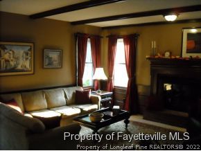 6823 Uppingham Road Fayetteville, NC 28306 - Photo 6 of 18 a living room with furniture and a fireplace