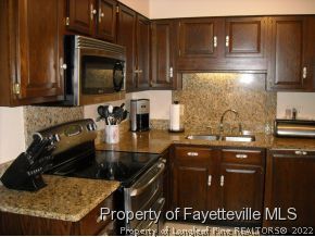 6823 Uppingham Road Fayetteville, NC 28306 - Photo 9 of 18 a kitchen with a sink and cabinets