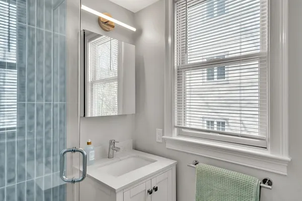 a bathroom with a sink a vanity and a mirror