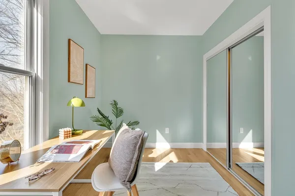 a bedroom with a bed and a lamp next to a window