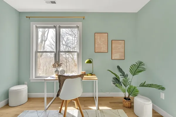 a dining room with furniture and wooden floor