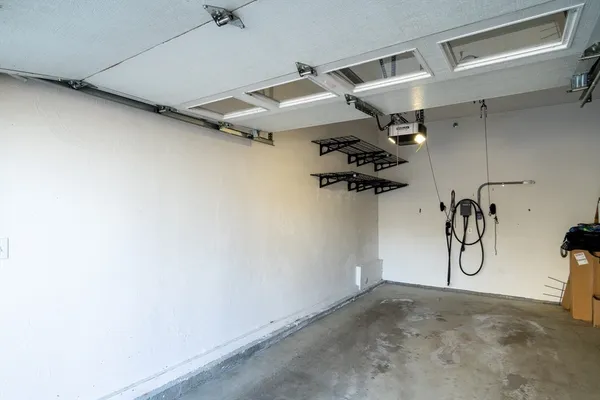 a view of a room with a hanging ceiling fan