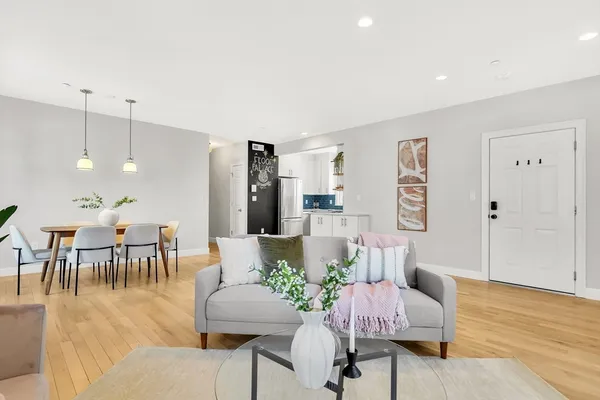 a living room with furniture and wooden floor