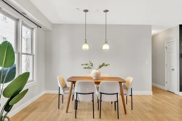 a view of a dining room with furniture window and wooden floor
