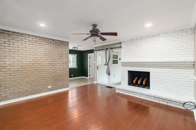 a view of an empty room with a fireplace and a window
