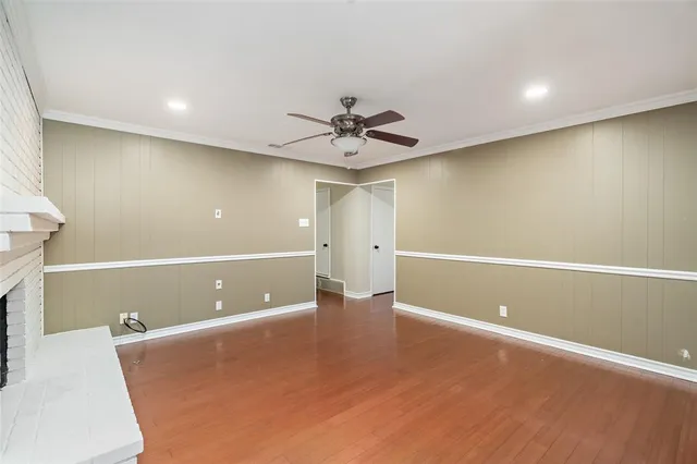 an empty room and chandelier fan