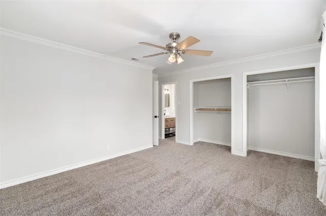 a view of an empty room with a ceiling fan