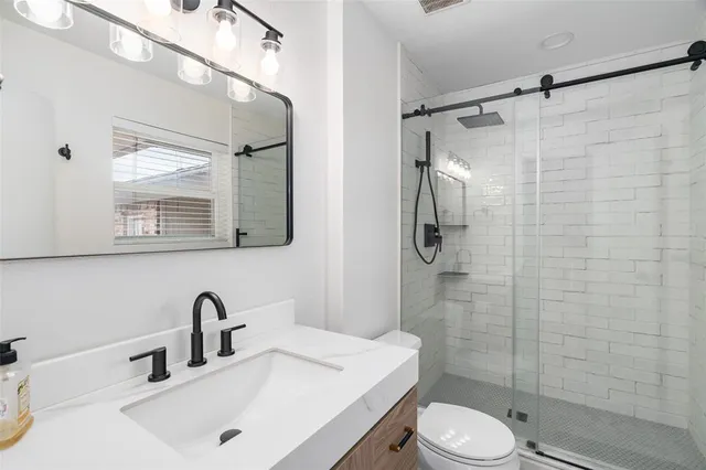 a bathroom with a sink toilet and shower