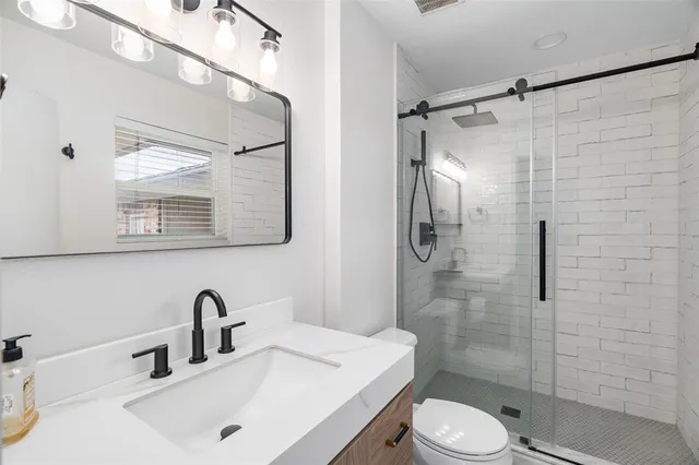 a bathroom with a sink toilet and shower