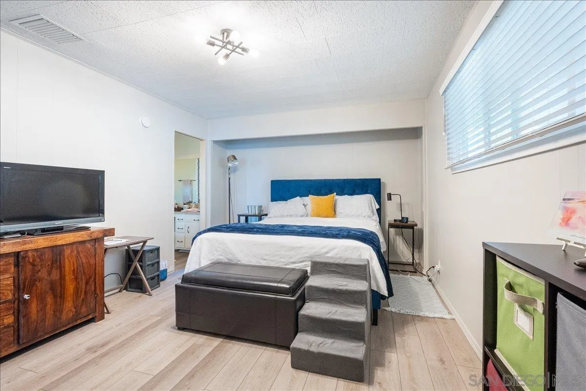 90 Blue Sky Lane Oceanside, CA 92056 - Photo 19 of 26 a bedroom with a bed and flat screen tv