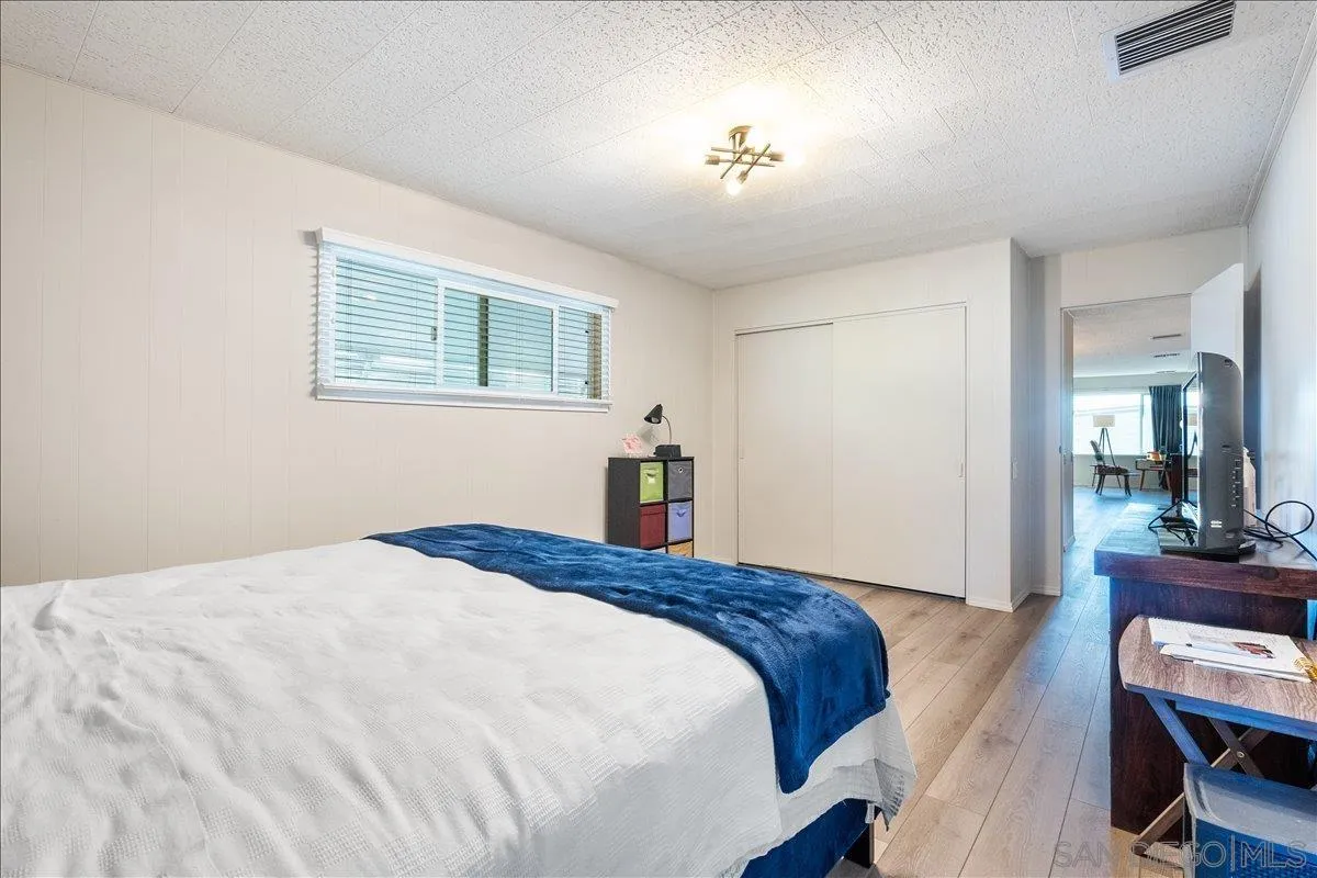 90 Blue Sky Lane Oceanside, CA 92056 - Photo 20 of 26 a bedroom with a bed and a chandelier
