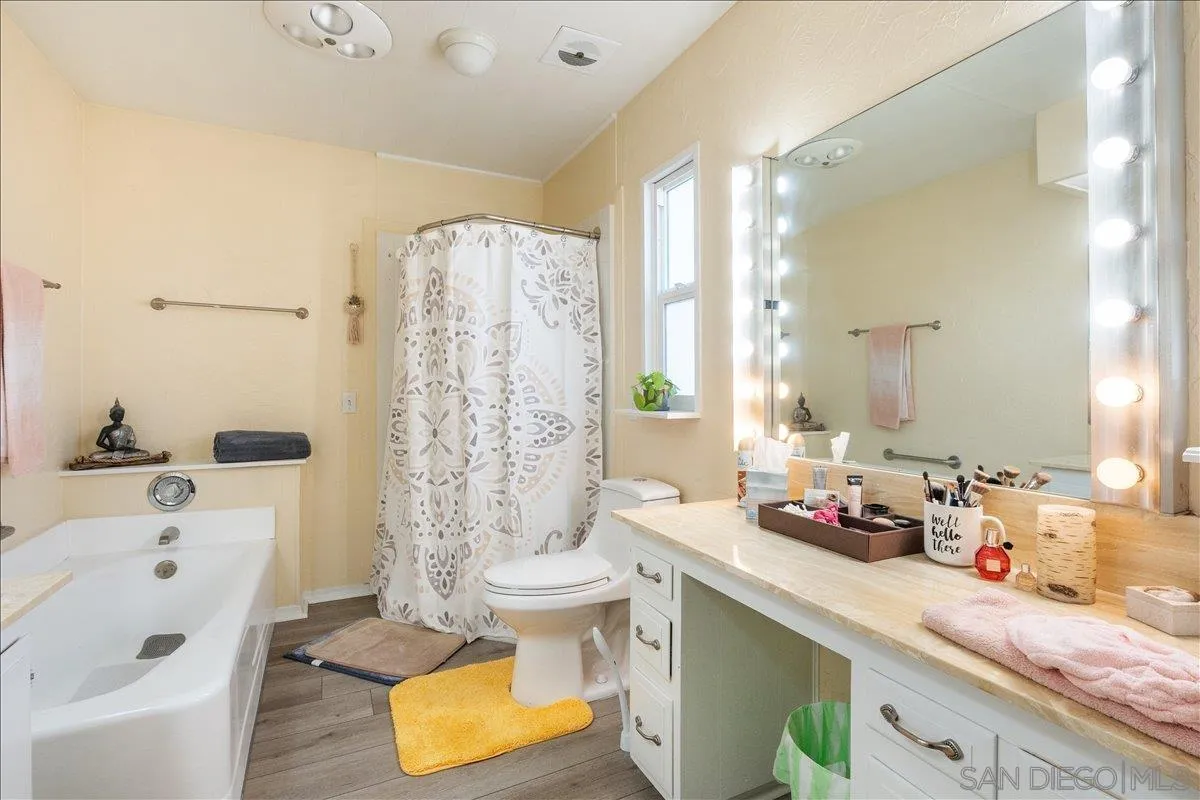 90 Blue Sky Lane Oceanside, CA 92056 - Photo 22 of 26 a bathroom with a granite countertop sink and a mirror