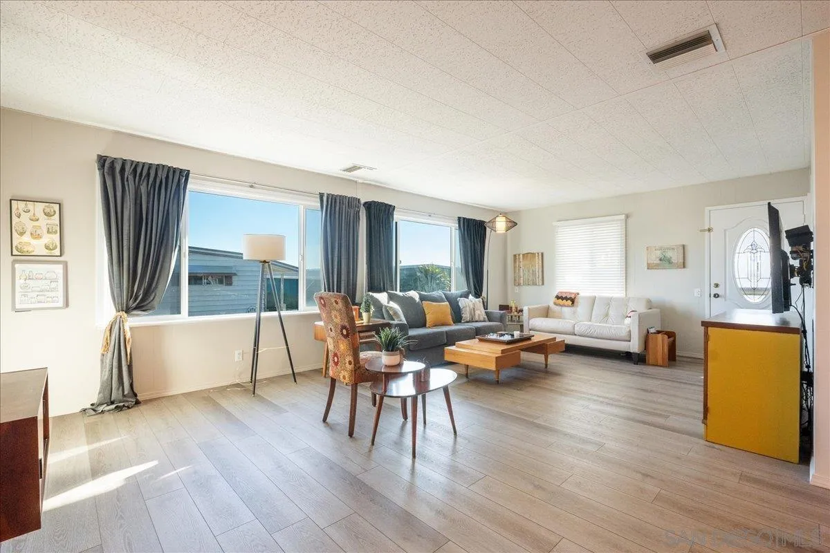 90 Blue Sky Lane Oceanside, CA 92056 - Photo 4 of 26 a living room with furniture and a wooden floor