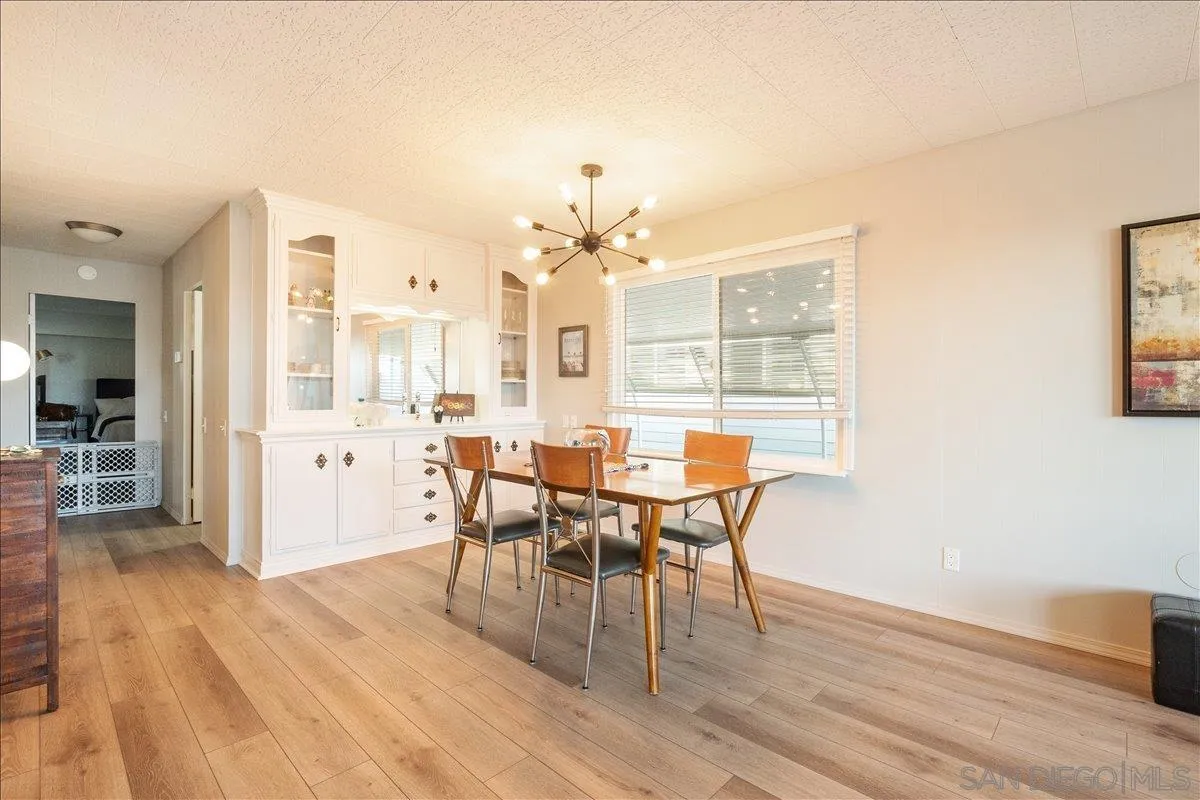 90 Blue Sky Lane Oceanside, CA 92056 - Photo 8 of 26 a view of a dining room with furniture and wooden floor