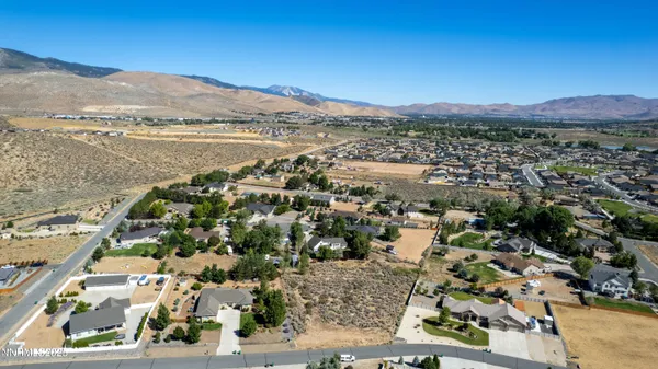 an aerial view of residential house and sandy dunes