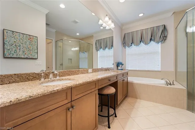 a bathroom with a granite countertop sink a toilet and bathtub