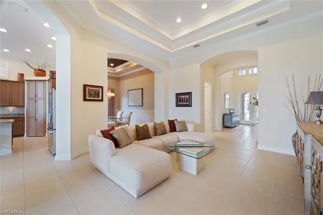 a living room with furniture and a view of kitchen