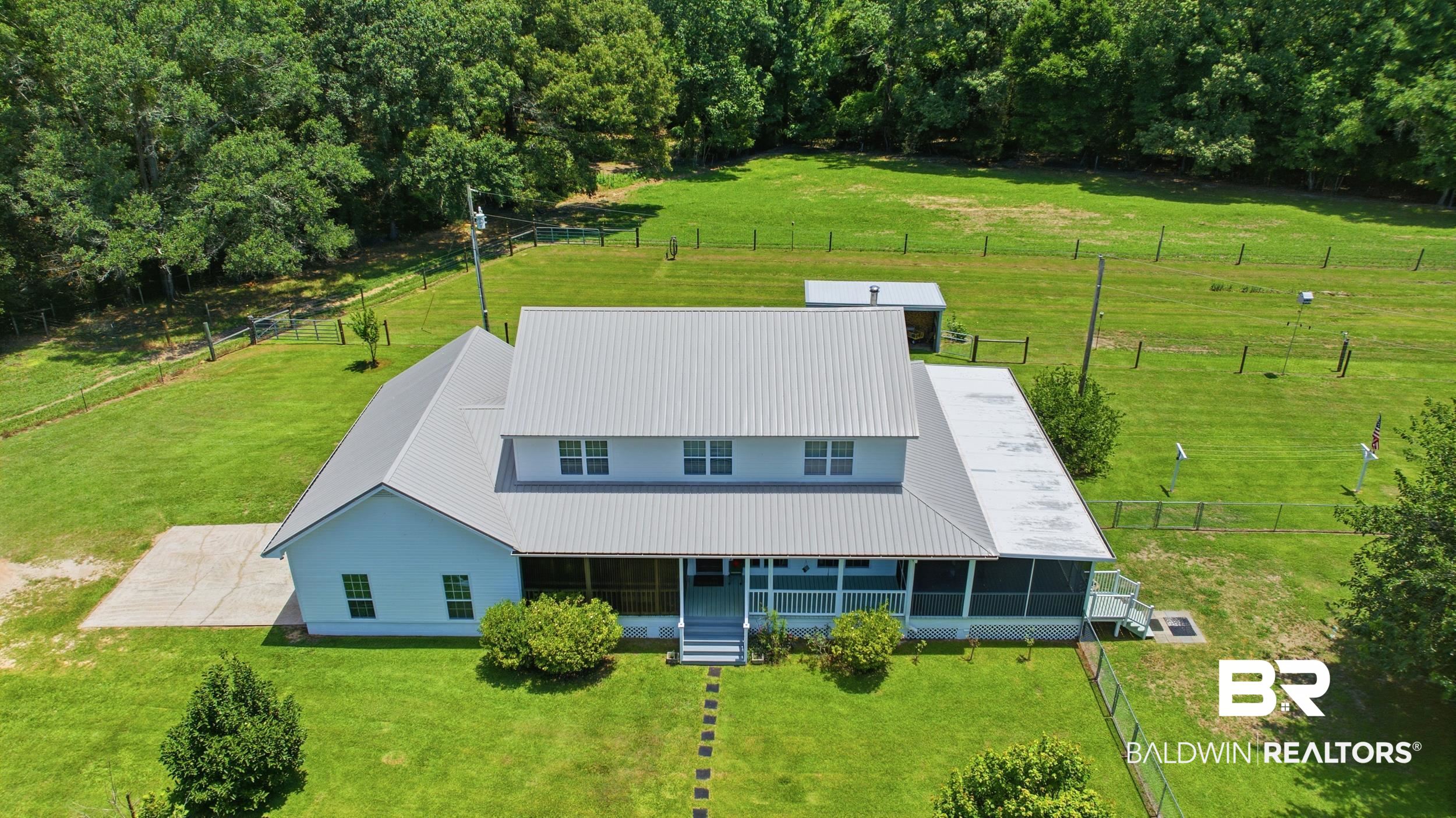 15855 Calvin Richerson Road Bay Minette, AL 36507 - Photo 11 of 83 Two-story residence featuring a gray metal roof and screened-in porch
