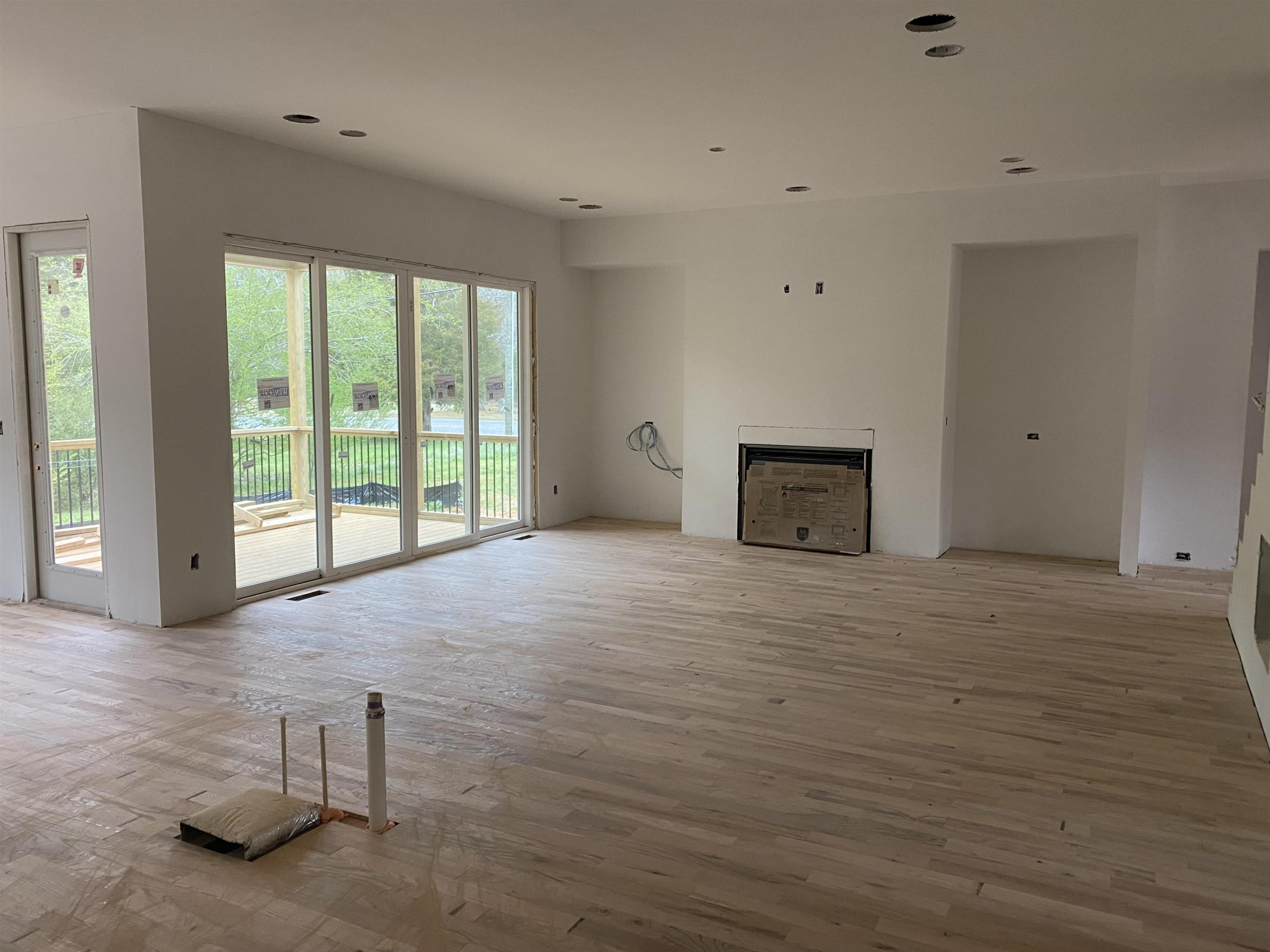 9121 Breeland Way Raleigh, NC 27613 - Photo 8 of 24 Family room with built ins, site finished hardwoods and easy access to the screen porch. Family Room