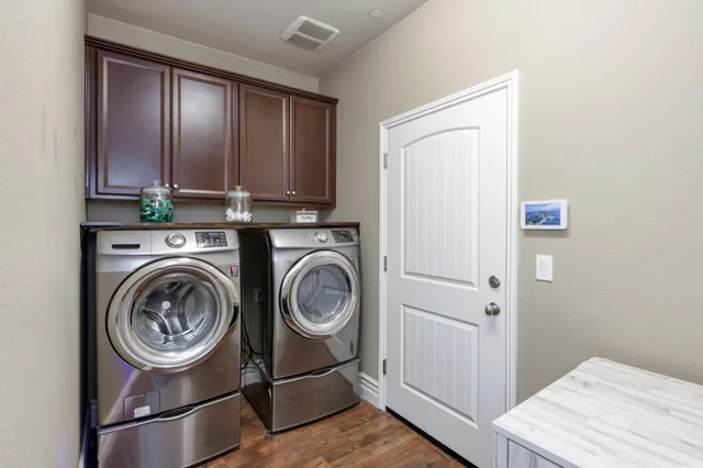 a view of a storage and utility room with washer and dryer