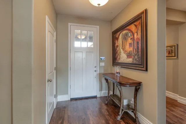 a view of a workspace with furniture and wooden floor