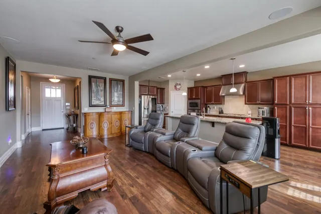 a living room with furniture and kitchen view