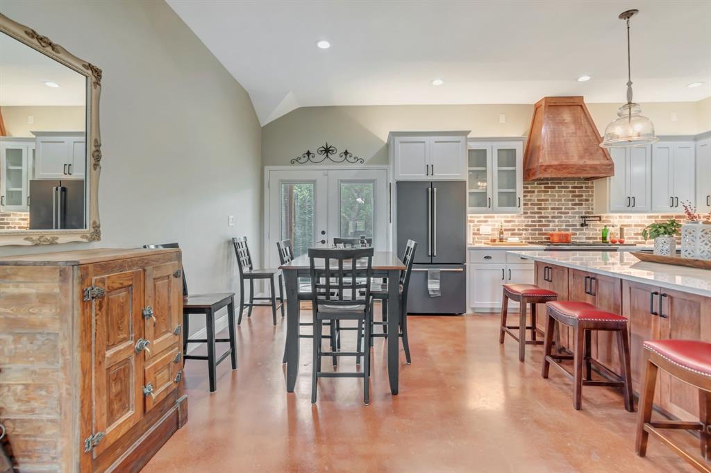 129 Whiskey Rnch Road Runaway Bay, TX 76426 - Photo 12 of 39 a open kitchen with stainless steel appliances granite countertop a dining table chairs and white cabinets