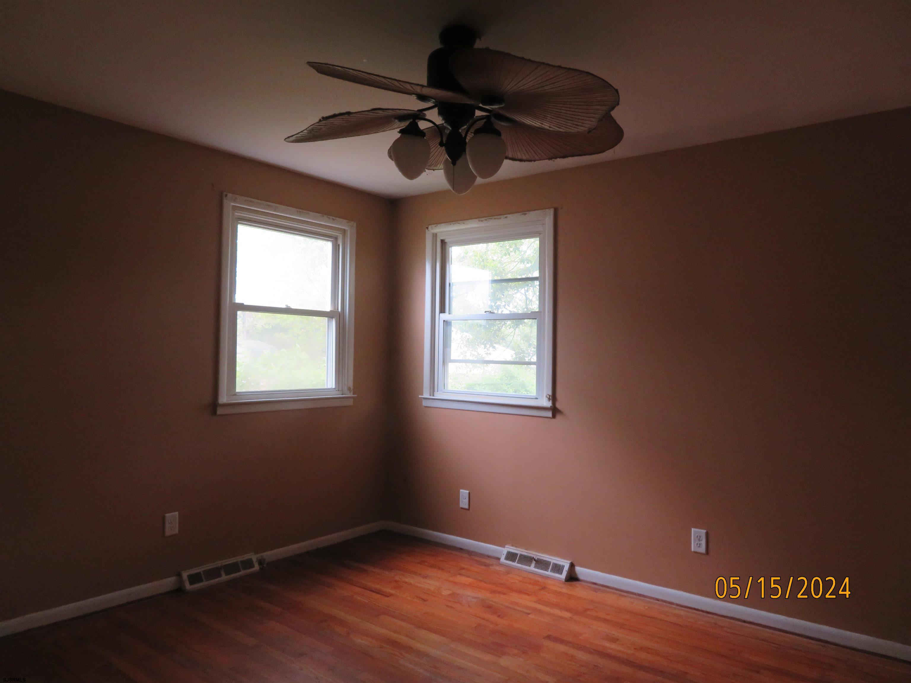1830 Birch Grove Road Northfield, NJ 08225 - Photo 8 of 11 a view of an empty room with wooden floor and a window